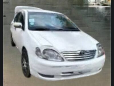 Image 1 (Front View): Front three-quarter view of a white 2003 Toyota Corolla X E120 sedan for sale in Addis Ababa.