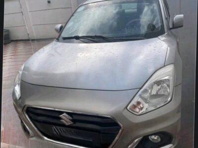 1.Front view of a silver 2022 Suzuki Dzire sedan parked in Addis Ababa showing the chrome grille and headlights.