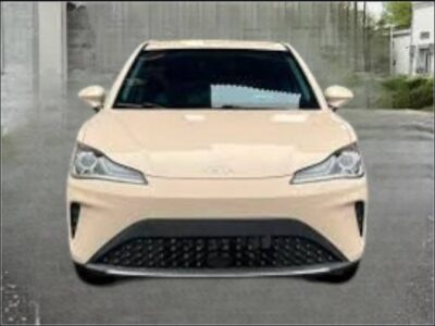 Image 1: Front view of the beige 2023 Hozon Neta AYA electric crossover SUV parked outdoors