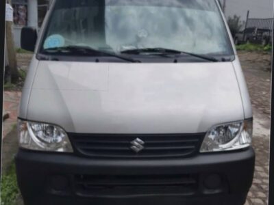 Image 2 (Front View): Front view of 2024 Suzuki Eeco passenger van showing clean headlights bumper and front grille