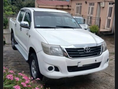 Image 2: Front right angle view of white 7th generation Toyota Hilux Double Cab pickup truck