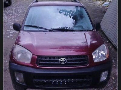 3 (Toyota RAV4 XA20.jpg): Front exterior view of 2005 Toyota RAV4 XA20 showing Salsa Red Pearl bonnet, black front bumper, mesh grille, and roof rails.