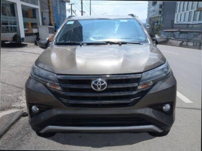 Image 5 (Front Angle View): Close-up front grille view of a brown Toyota Rush GR-Sport SUV
