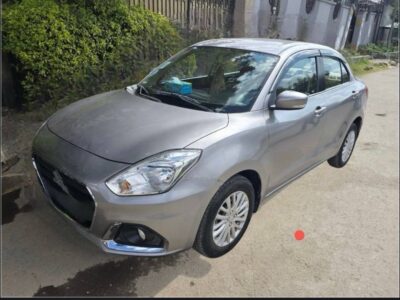 4:Front left quarter view showing headlights, bumper, and windshield of Suzuki Dzire