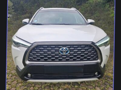 Image 5 (Toyota Corolla Cross Hybrid (XG10).jpg): Front grille and LED headlights of the white Toyota Corolla Cross Hybrid for sale